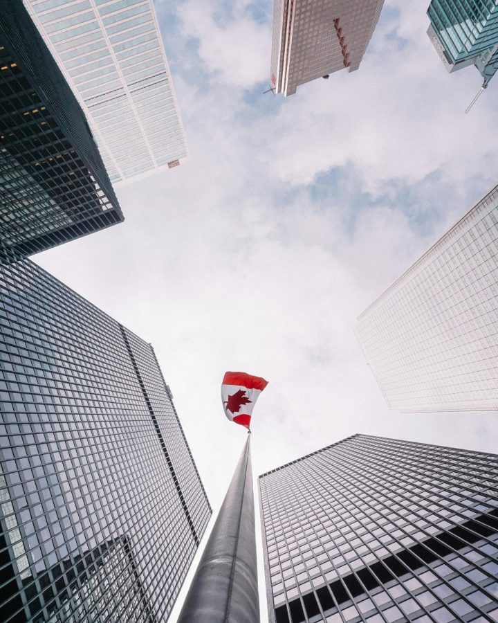 Office towers and a Canadian flag seen from street level